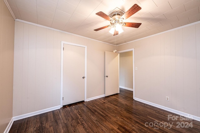 unfurnished bedroom with dark hardwood / wood-style floors, ceiling fan, and ornamental molding