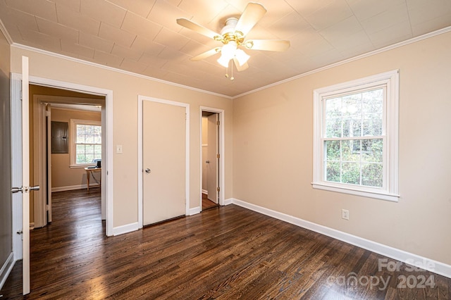 unfurnished bedroom with ceiling fan, ornamental molding, dark wood-type flooring, and multiple windows