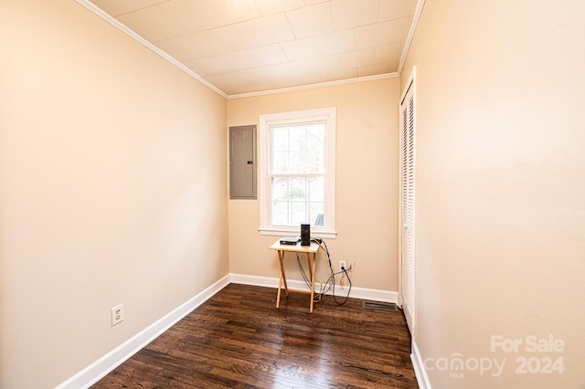 unfurnished bedroom featuring dark hardwood / wood-style flooring, crown molding, and electric panel