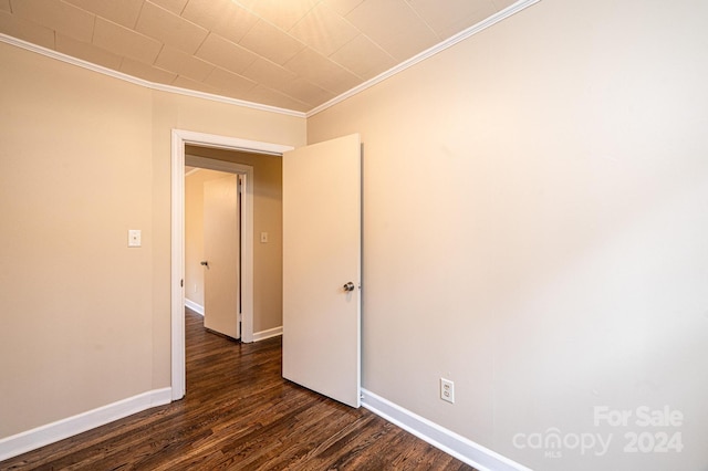 unfurnished room with dark hardwood / wood-style floors and ornamental molding