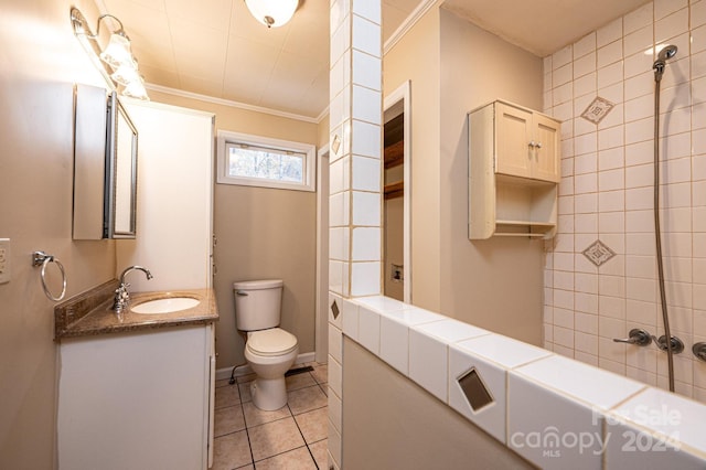 bathroom featuring tile patterned flooring, vanity, ornamental molding, and toilet