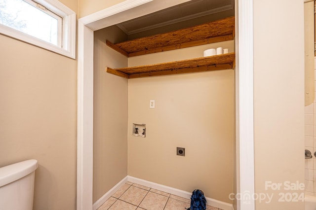 washroom with electric dryer hookup, hookup for a washing machine, and light tile patterned floors