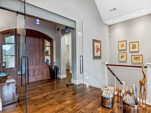 22 Foxbridge Way, Arden, NC 28704 - foyer entrance featuring wood finished floors, arched walkways, high vaulted ceiling, and baseboards