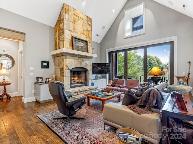 22 Foxbridge Way, Arden, NC 28704 - living room with high vaulted ceiling, dark wood-style flooring, a stone fireplace, and baseboards