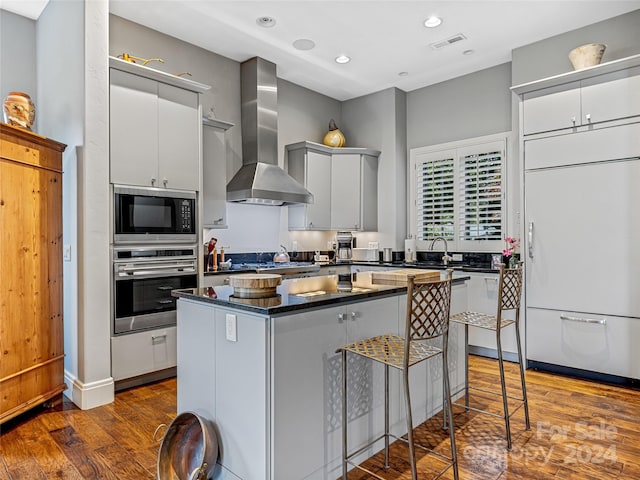 22 Foxbridge Way, Arden, NC 28704 - kitchen with built in appliances, wall chimney range hood, dark wood-style floors, dark countertops, and recessed lighting