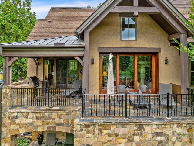 22 Foxbridge Way, Arden, NC 28704 - rear view of property with a standing seam roof, a patio, stucco siding, metal roof, and area for grilling