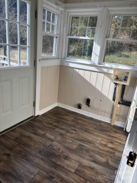 interior space featuring dark wood-style flooring and a healthy amount of sunlight