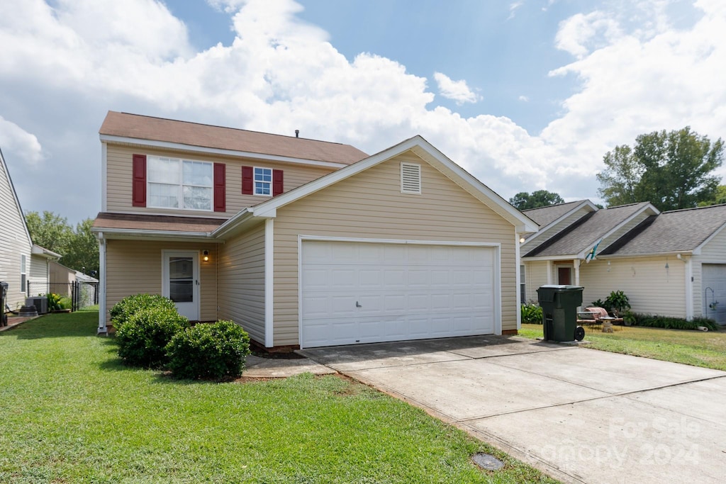 traditional-style home featuring a garage, central AC, a front lawn, and concrete driveway