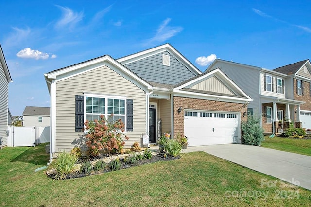 view of front of house featuring a garage and a front lawn