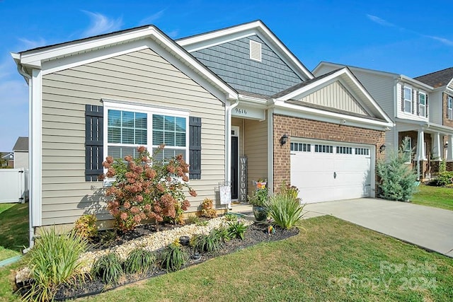 view of front of property with a garage and a front lawn