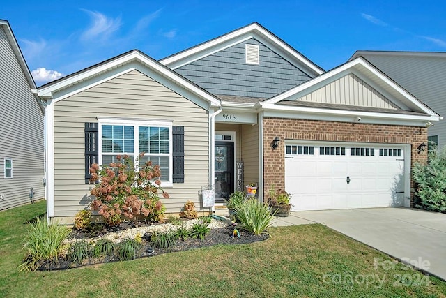 view of front of house featuring a garage and a front lawn