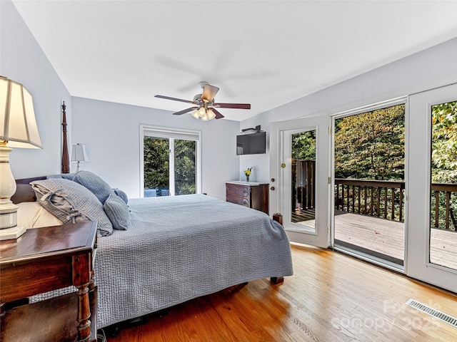 bedroom with access to outside, ceiling fan, and multiple windows