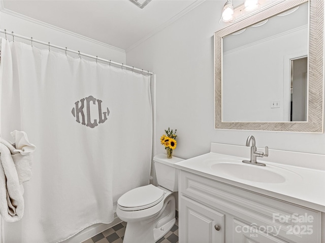 bathroom with toilet, vanity, and crown molding