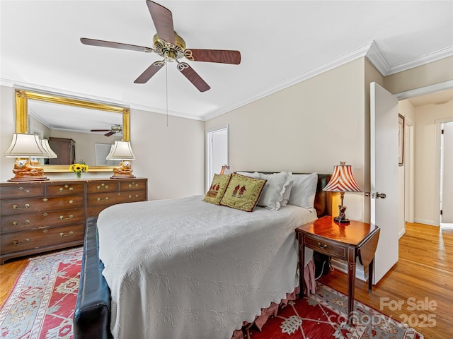 bedroom featuring ceiling fan, ornamental molding, and hardwood / wood-style floors