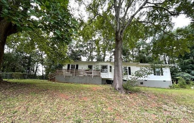 rear view of property featuring a wooden deck