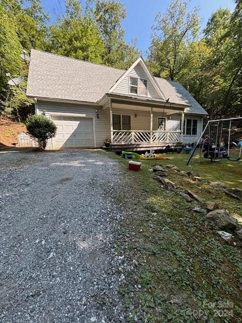 view of front facade with covered porch and a garage