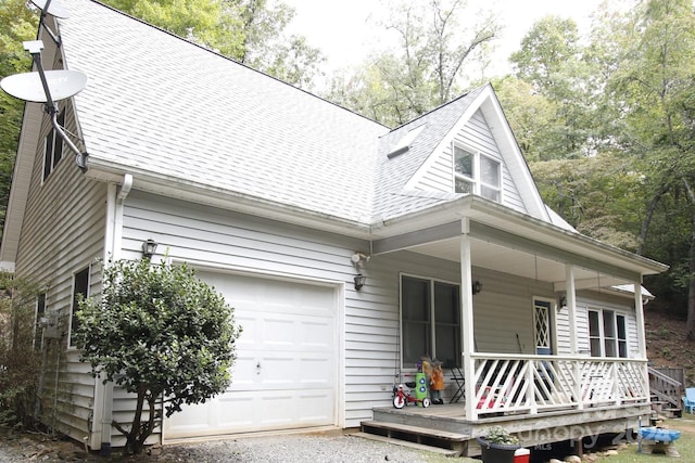 view of front of property with covered porch and a garage