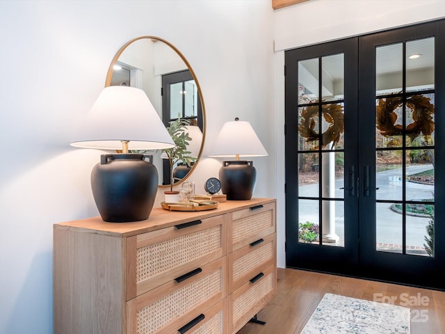 entryway with french doors and light hardwood / wood-style flooring