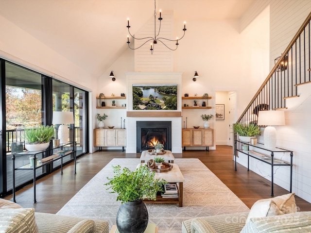 living room featuring high vaulted ceiling, dark wood-type flooring, and a chandelier