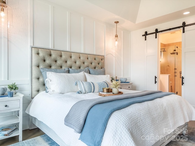 bedroom with lofted ceiling and a barn door