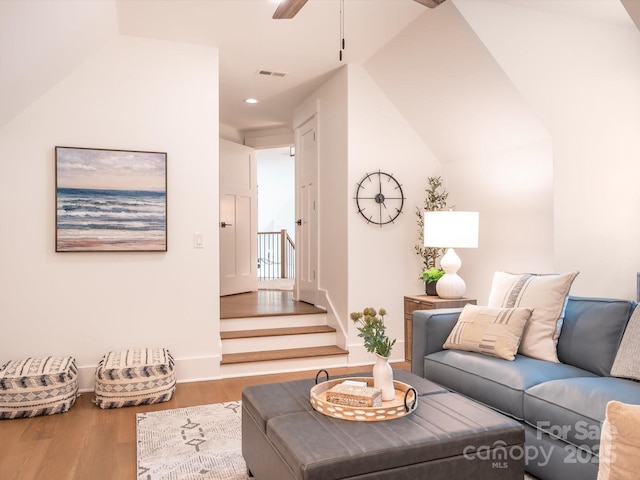 living room with hardwood / wood-style flooring, lofted ceiling, and ceiling fan