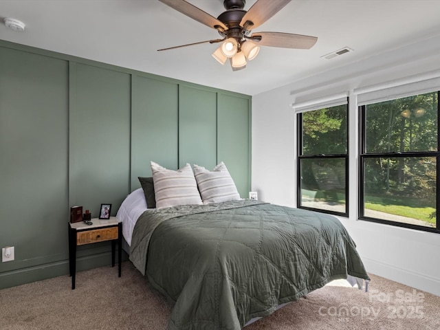 bedroom with ceiling fan and light colored carpet