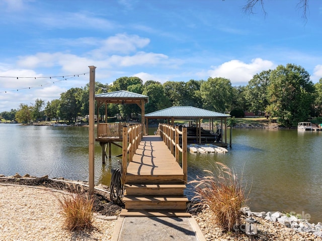 view of dock with a gazebo and a water view