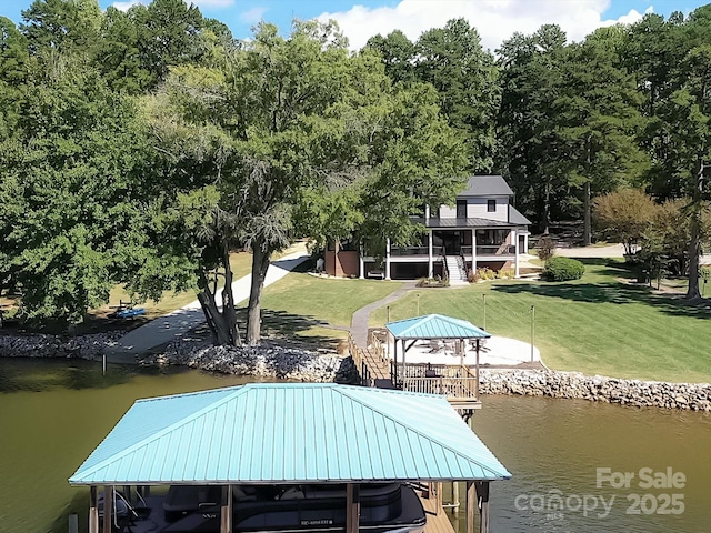 dock area featuring a water view, a gazebo, and a yard