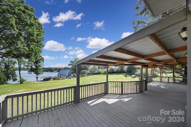 wooden deck featuring a lawn and a water view