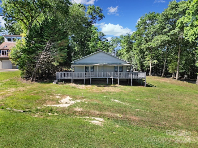 view of yard with a garage and a wooden deck