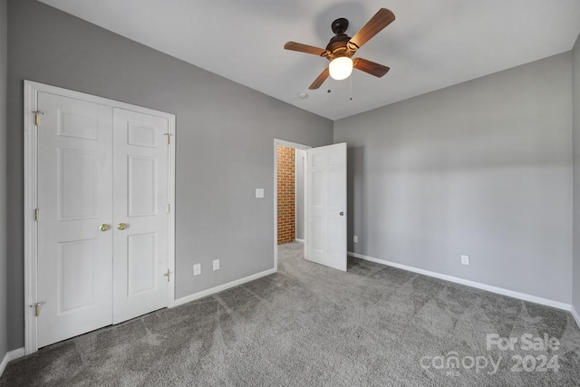 unfurnished bedroom with ceiling fan, a closet, and carpet