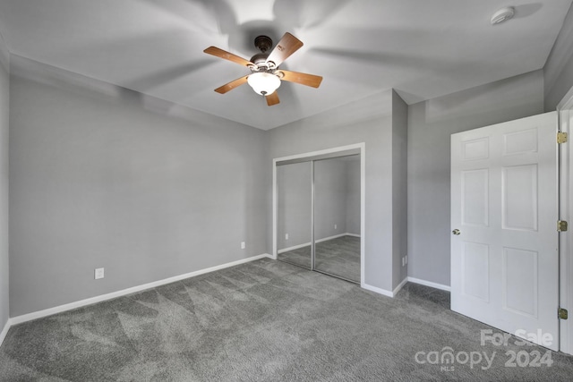 unfurnished bedroom featuring carpet floors, ceiling fan, and a closet