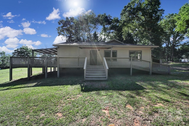 back of house featuring a deck and a lawn