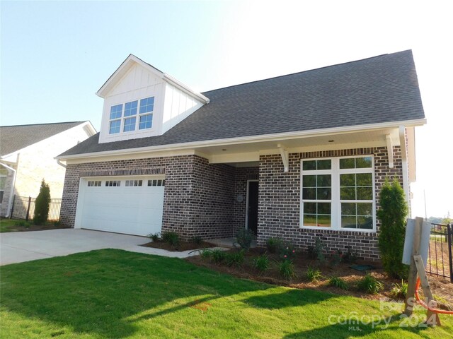 view of front of house with a garage and a front yard