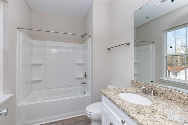 full bathroom with hardwood / wood-style floors, vanity, toilet, and shower / tub combination