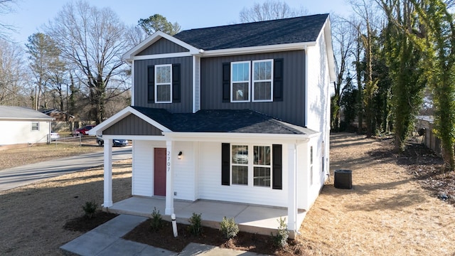 view of front of property featuring cooling unit and a porch