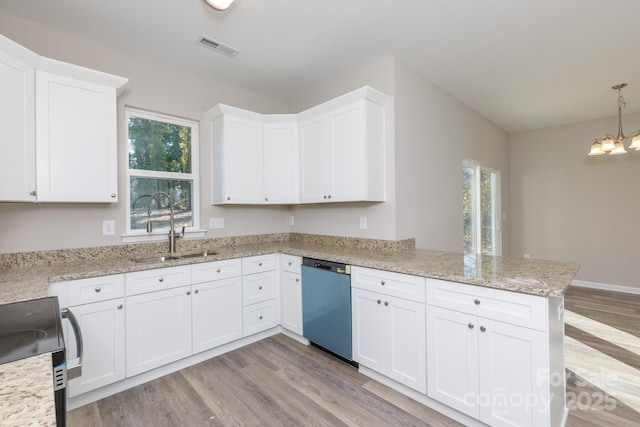 kitchen with dishwasher, white cabinets, sink, decorative light fixtures, and kitchen peninsula