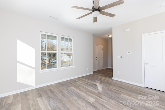 spare room featuring light wood-type flooring and ceiling fan