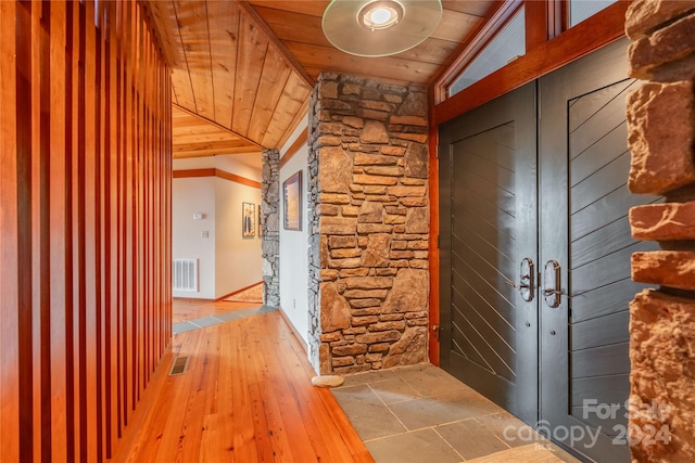 interior space featuring wood ceiling, hardwood / wood-style floors, and vaulted ceiling