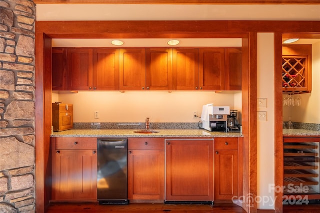 kitchen with light stone countertops, beverage cooler, sink, and dark hardwood / wood-style floors