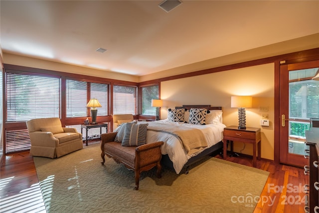 bedroom featuring visible vents and wood finished floors