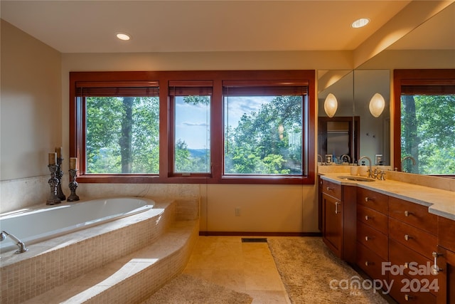 bathroom featuring vanity, baseboards, visible vents, recessed lighting, and a garden tub