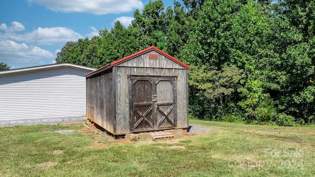 view of outdoor structure with a lawn