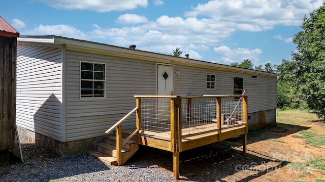 back of house featuring a wooden deck