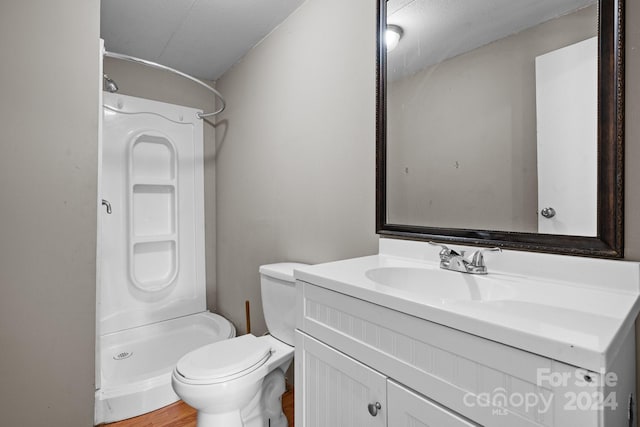 bathroom featuring walk in shower, toilet, hardwood / wood-style flooring, and vanity