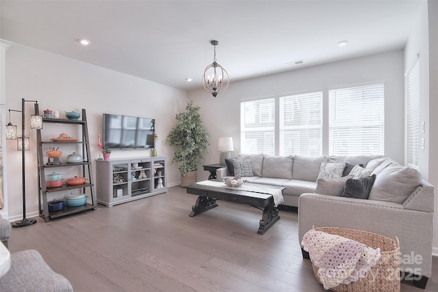 living room with a notable chandelier and wood-type flooring