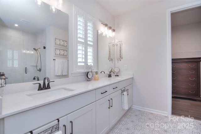 bathroom with tile patterned flooring, vanity, plenty of natural light, and an enclosed shower