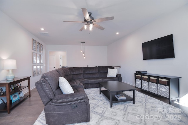 living room featuring ceiling fan and wood-type flooring