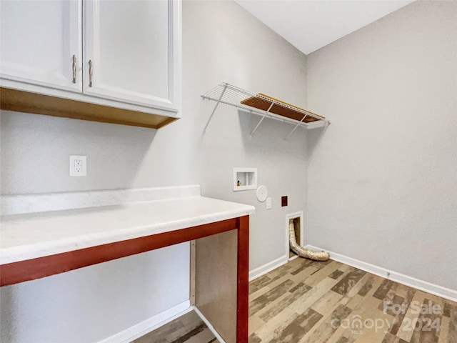 laundry area with hookup for a washing machine, hookup for an electric dryer, baseboards, cabinet space, and light wood finished floors