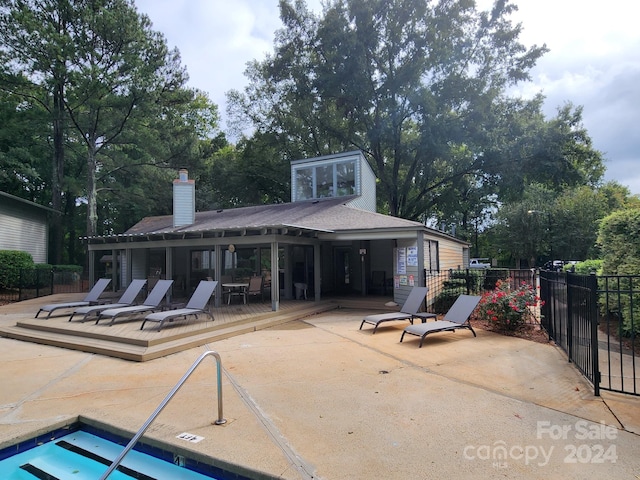 exterior space with a pool side deck and a patio area